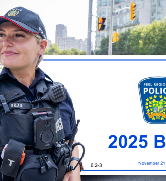 Police officer in community standing in front of the banner of the 2025 Peel Region Police Budget